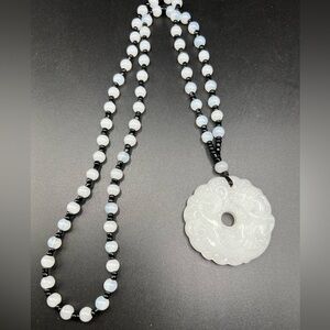 Asian style glass necklace with carved pendant